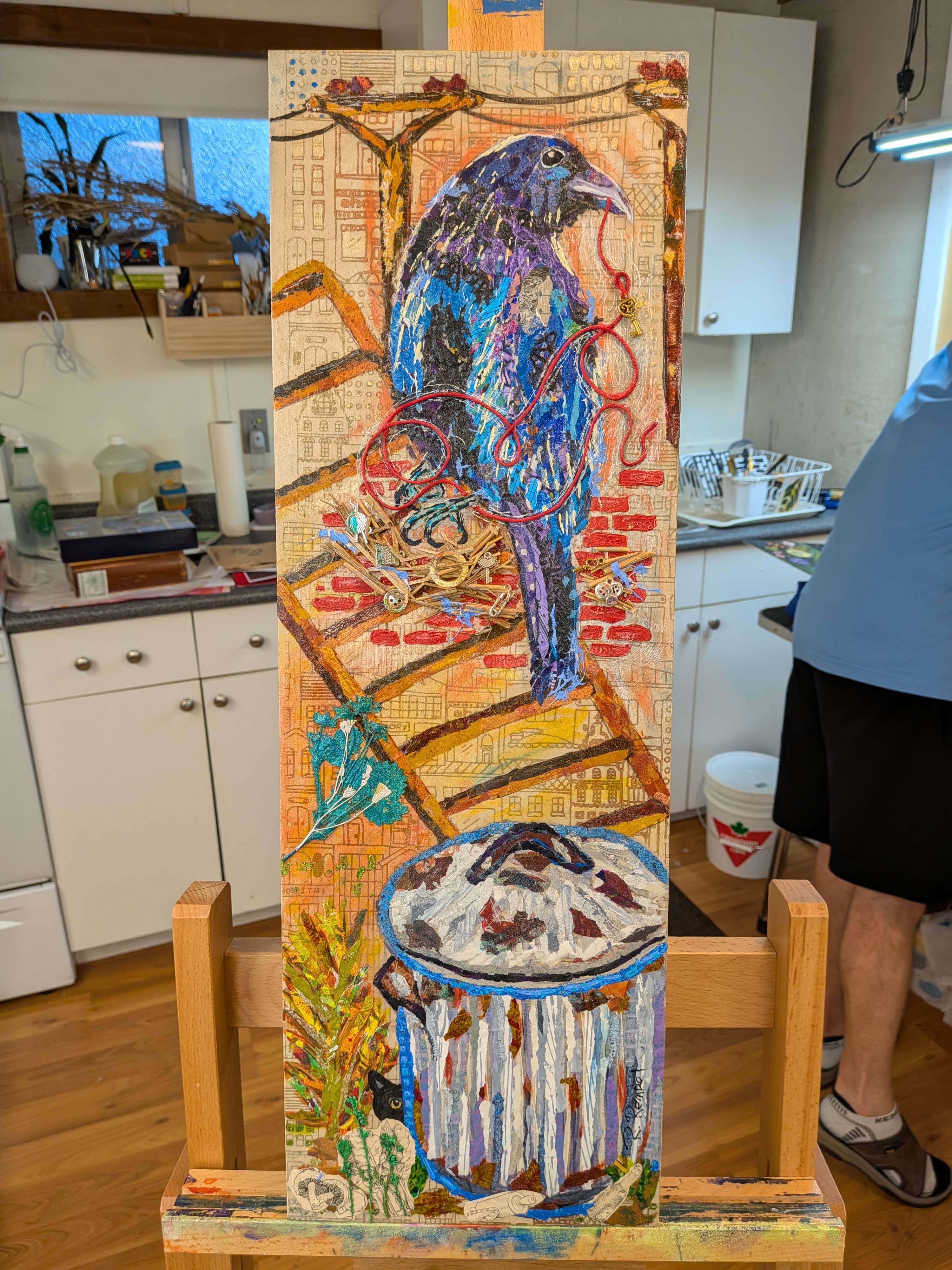 Tall collage of a raven perched among red bricks and city textures